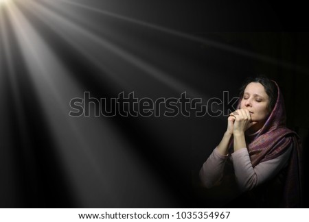 Dramatic evangelical pentecostal pious kneeling grieve young white lady cover head for ask implore wish upwards Jesus Christ. Vintage repentance concept copyspace with space for text on dark backdrop