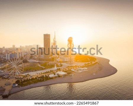 Dramatic evening in Batumi from aerial perspective with beautiful architecture buildings in foreground and setting sun in background. Georgia travel destination 2023