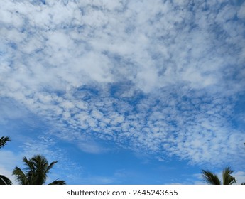 The dramatic evening sky is filled with a blend of cumulus and stratus clouds, creating a moody and atmospheric scene