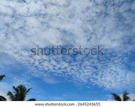 The dramatic evening sky is filled with a blend of cumulus and stratus clouds, creating a moody and atmospheric scene