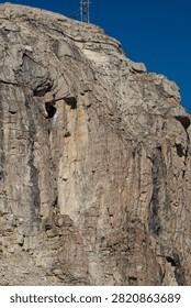 Dramatic exposed rock formations along the rugged slopes of the Teton Range in Grand Teton National Park, Wyoming. The striking geological textures and weathered mountain rock showcase the raw beauty and dramatic geology of the Rocky Mountain landscape in summer.