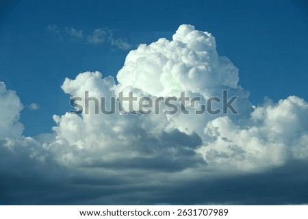 Dramatic formation of storm clouds in bright and deep blue tropical summer sky. Copy space.