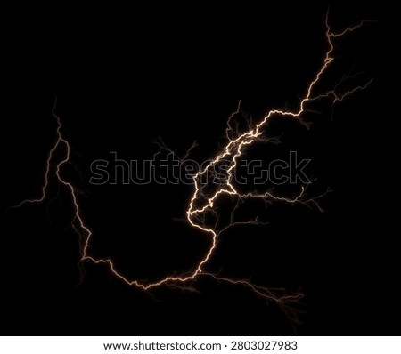 Dramatic golden electrical discharge and lightning strikes with branching effects isolated on a black background.