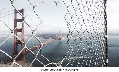 Dramatic Golden Gate Bridge through fence