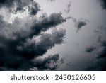 Dramatic gray-white cloudy sky with storm clouds and passing wispy clouds of a heavy thunderstorm