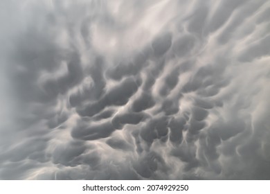 Dramatic grey clouds in the sky. Sky with stratocumulus and cirrus clouds on a stormy day