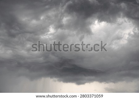 Dramatic grey raincloud landscape in the sky.