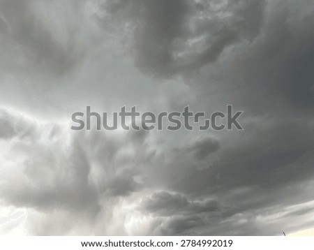 Dramatic grey storm cloud formation filling the sky with intense moody atmospheric weather scenery
