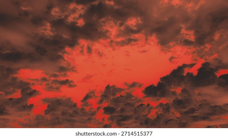 Dramatic, hellish sky with dark, fiery red clouds framing a glowing center. Apocalyptic, ominous weather background