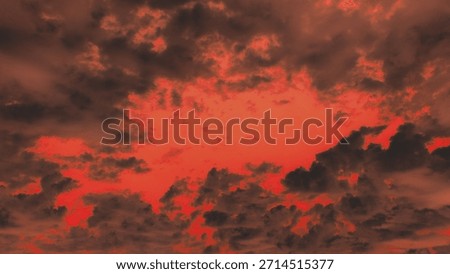 Dramatic, hellish sky with dark, fiery red clouds framing a glowing center. Apocalyptic, ominous weather background