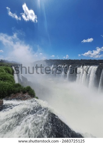A dramatic, high-angle shot capturing the immense power of a major waterfall where the massive volume of water plunges over the edge.