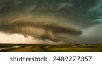 A dramatic horizon of a stormy sky with lightning striking over a green field in Nebraska Plains,USA