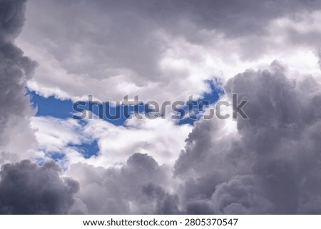 Dramatic horizontal band of intense white light breaking through dark storm cloud layers. Powerful contrast between illuminated and shadowed areas. Perfect for breakthrough, revelation, and dramatic weather concepts.