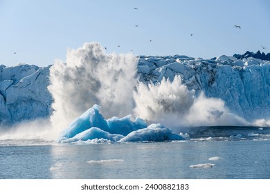 Dramatic ice calving from the Monacobreen Glacier in Liefde Fjord, small tidal wave and icebergs floating in the arctic ocean around Svalbard, signs of climate change and global warming
 - Powered by Shutterstock