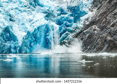 Dramatic iceberg crashing into water