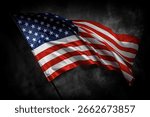 A dramatic image of the American flag waving against a dark cloudy background, symbolizing patriotism, freedom, and national pride.