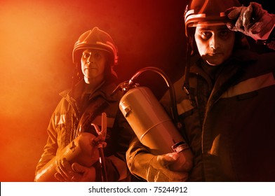 Dramatic image of firemen team in uniform