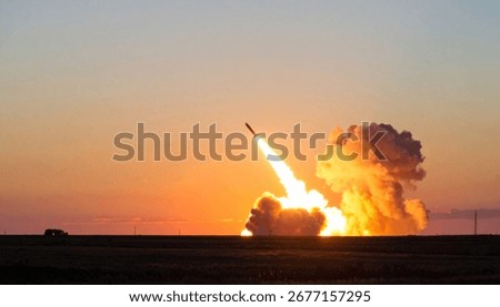 Dramatic image of a missile launching at sunset. The fiery exhaust plume contrasts against the orange sky.