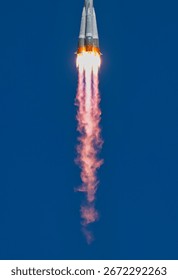 Dramatic image of rocket launching into sky with powerful flames. Space rocket launch smoke. Rocket launching into a clear sky with vibrant color. Elements of this image furnished by NASA