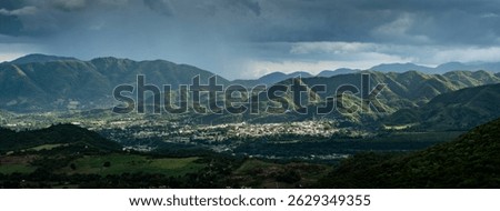 Dramatic image of a small town of Ocoa in the Dominican Republic high in the mountains at sunrise, layered mountains and cloudy skies.
