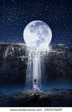 Dramatic and imaginary moon waterfall. moon waterfall in starry night. girl on cliff enjoying full moon night and waterfall.
