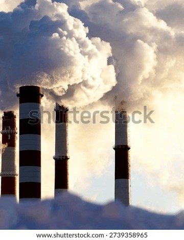 Dramatic industrial scene featuring red and white factory chimneys releasing thick smoke and steam into the sky.