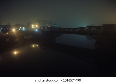 Dramatic Industrial Vintage River Bridge Scenery At Night With Illuminating Fog In Chicago.