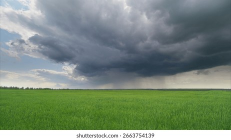 Dramatic and Intense Storm Clouds Floating Above the Vibrant Lush Green Fields in Nature