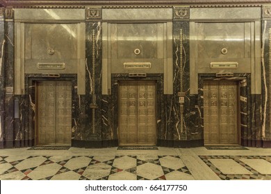 Dramatic interior of a vintage urban skyscraper with golden elevators, vast marble floors and retro vintage style in urban Detroit Michigan