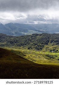 Dramatic interplay of light and shadow across mountain ridges. The varied textures and cool tones enhance the mood, creating a captivating vista.