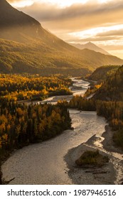 dramatic landscape of autumn foliage in the Matanuska River and snow capped mountains of the Chugach mountain range in Alaska	