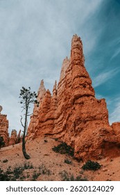 Dramatic landscape of Bryce Canyon under a cloudy blue sky