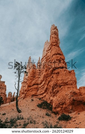 Dramatic landscape of Bryce Canyon under a cloudy blue sky