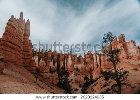 Dramatic landscape of Bryce Canyon under a cloudy blue sky