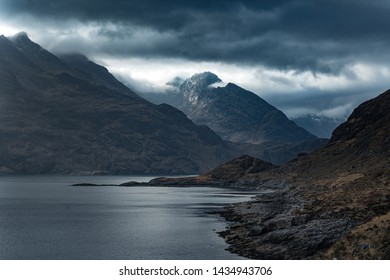 Dramatic landscape coastline view of rocks and Cullin hills, Scotland, United Kingdom. misty clouds, Morning hilly landscape - Powered by Shutterstock