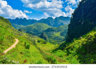 Dramatic Landscape of a Deep Green Valley Surrounded by Towering Karst Mountains under a Cloudy Sky in Ha Giang, Vietnam