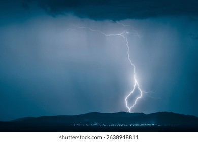 A dramatic landscape featuring a powerful lightning strike illuminating a dark sky over distant hills with city lights below.