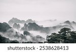 A Dramatic landscape of foggy mountains in the distance: Huangshan National park China