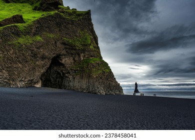 Dramatic landscape of Halsanefshellir cave with Reynisdrangar natural rock formation on Reynisfjara black sand beach in gloomy day during summer at South of Iceland - Shutterstock ID 2378458041
