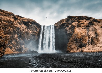 Dramatic landscape of powerful Skogafoss waterfall flowing from volcanic mountain in autumn at South of Iceland - Powered by Shutterstock