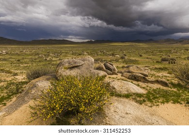 Dramatic landscape with rain clouds over the valley and mountains.