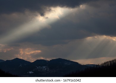 Dramatic landscape with rays of the sun breaking through the clouds