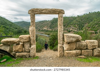 Dramatic Landscape of the Tejo River Seen Through a Traditional Stone Arch