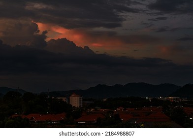 Dramatic landscape with view on evening city. Beautiful cloudy sky.