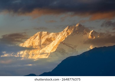 Dramatic last light from setting sun on Mount Kanchenjugha, Himalayan mountain range, Sikkim, India. color tint on the mountains at dusk. Tourist destination for viewing Himalayan mountain range.