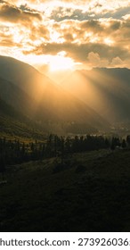 Dramatic Light Beams Breaking Through Clouds for Inspirational Background, Concept of Hope and Journey Golden God Rays Shining Over Epic Mountain Landscape