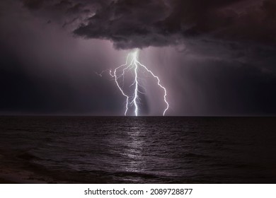 Dramatic Lightening, Thunder Bolt In Night Sky Over Sea