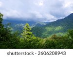 Dramatic lighting on forested ridges in Great Smoky Mountains National Park with clouds rolling over the peaks