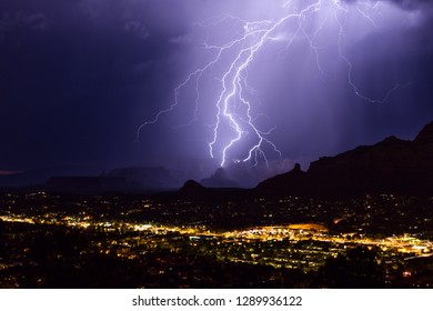 A dramatic lightning bolt strikes a canyon during a monsoon storm in Sedona, Arizona