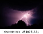 Dramatic lightning stikes in a summer thunderstorm painting the sky